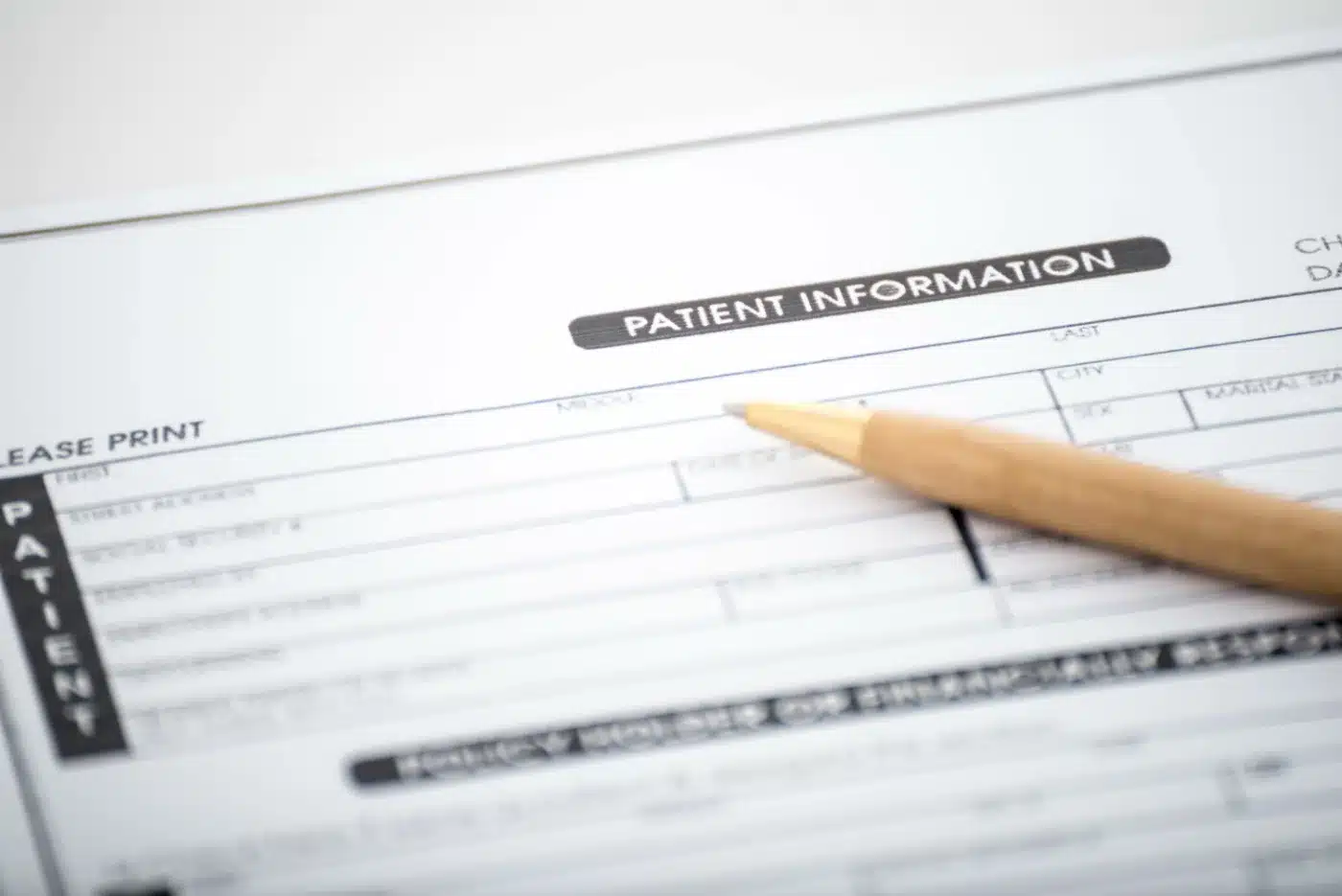 Patient information form and pen on desk,Medical questionnaire Patient information form and pen on desk,Medical questionnaire