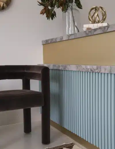 Custom reception desk with fluted teal panels and marble counter at Elite Dermatology. Custom reception desk with fluted teal panels and marble counter at Elite Dermatology.